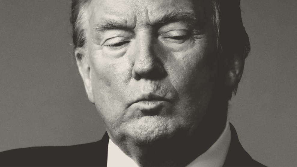 Close-up of Donald Trump looking down with his lips pursed.