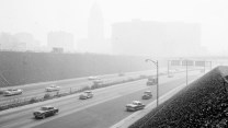 A picture of cars driving on the highway as smog covers Los Angeles